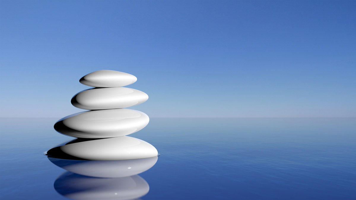 Zen stones in water with blue background